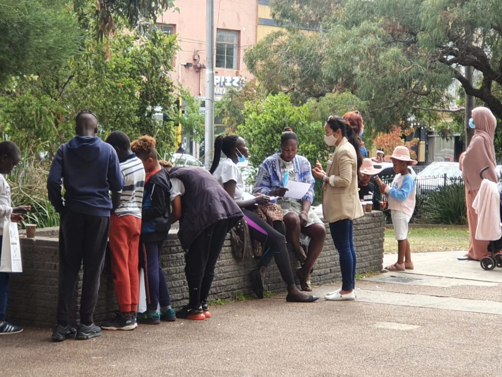 COVID education outreach photo - WHIN staff members speak with multicultural community members about vaccination 